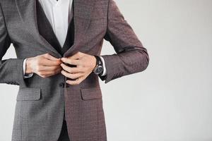 Close up view. Young stylish businessman in suit indoors. Conception of success photo