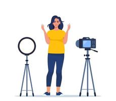 Blogger communicates in live stream with followers. Woman records video standing in front of the camera. Influencer creating video for a blog. Vector illustration.