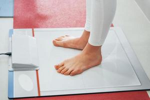 Woman standing on the scanner of feet. Conception of healthcare photo