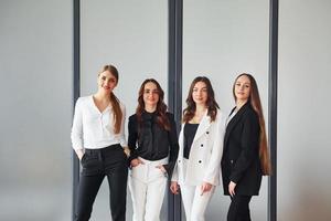 Group of adult women that in formal clothes is indoors in the office together photo