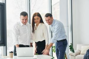 Group of people in official formal clothes that is indoors in the office photo