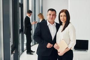 Group of people in official formal clothes that is indoors in the office photo