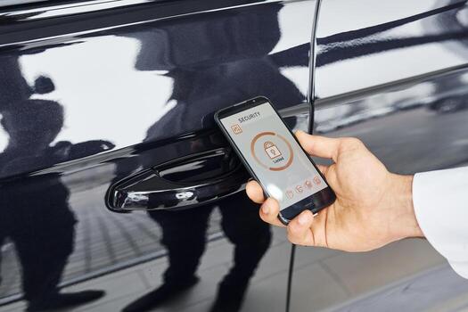 Close up view of man's hand that holds phone with labels and icons. Conception of remote control photo