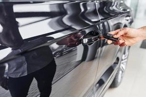 Close up view of man's hand that holds automobile keys photo