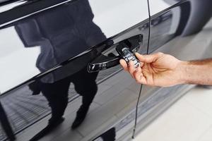 Close up view of man's hand that holds automobile keys photo