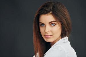 Portrait of young beautiful woman that posing for the camera in the studio photo