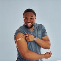 Young african american man after vaccine injection is indoors photo