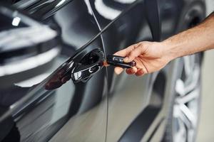 Close up view of man's hand that holds automobile keys photo