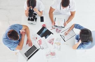 Top view. Group of young doctors is working together in the modern office photo