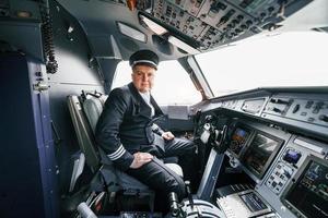 Pilot on the work in the passenger airplane. Preparing for takeoff photo