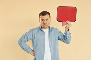 Facial expression. Man standing in the studio with empty signs for the text photo