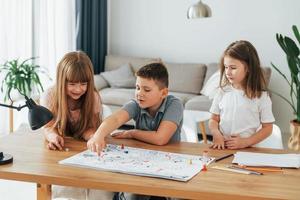 juego paso a paso. niños divirtiéndose juntos en la sala doméstica durante el día foto