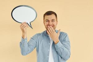 Positive emotions. Man standing in the studio with empty signs for the text photo