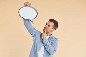 Ideas in the mind. Man standing in the studio with empty signs for the text photo