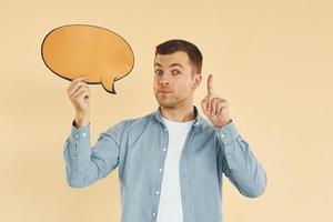 Facial expression. Man standing in the studio with empty signs for the text photo