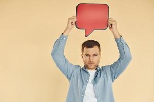 Facial expression. Man standing in the studio with empty signs for the text photo