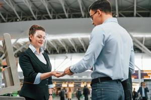 Checking documents. Young businessman in formal clothes is in the airport at daytime photo