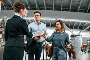 Checking documents at the entrance. Young couple is in the airport together photo