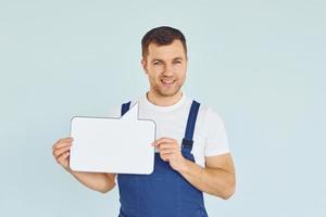 Worker saying something. Man standing in the studio with empty signs for the text photo