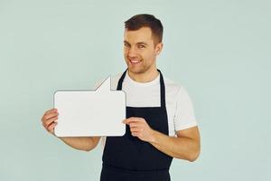 Sincere emotions. Man standing in the studio with empty signs for the text photo