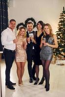 Conception of holidays. Group of people have a new year party indoors together photo