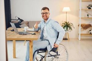 Working on a project from home. Disabled man in wheelchair photo