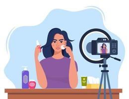mujer bloguera de belleza grabando video tutorial de cuidado de la piel para su vlog. chica hablando y mostrando productos cosméticos frente a la cámara. ilustración vectorial vector