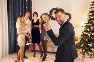 Conception of anticipation. Group of people have a new year party indoors together photo