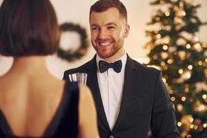 pareja feliz tiene una fiesta de año nuevo en el interior juntos foto