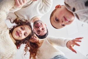 View from below. Happy family looking down and having fun photo