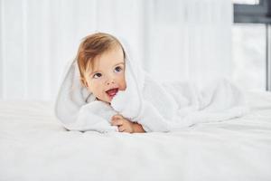 Positive emotions. Cute little baby is indoors in the domestic room photo