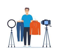 man blogger graba consejos en video para elegir ropa, muestra modelos de ropa de tendencia a sus suscriptores. promoción de marca o producto, campaña de marketing en medios sociales. ilustración vectorial vector