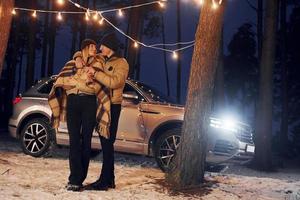 Conception of love. Couple standing in the forest and celebrating New year photo