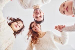 View from below. Happy family looking down and having fun photo