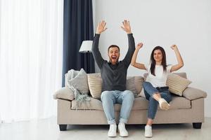 Happy owners of a new apartment is sitting on the sofa photo