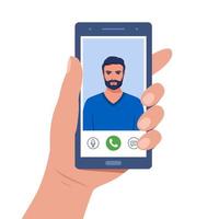 Hand holds smartphone during video call. Young man on smartphone screen with connection icons. Communication online using the phone. Talking through video call. Chatting online. Vector illustration.