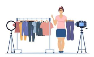 Woman blogger records video tips for choosing clothes, shows trending clothing models to her subscribers. Brand or product promotion, marketing campaign in social media. Vector Illustration.