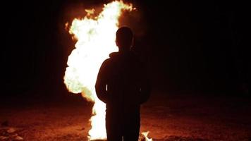 Young Man, Teen Boy Watches Flames Of Fire Engulfing A Pile Of Wood video