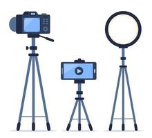 Camera, smartphone and ring light on tripods. Set of gadgets for shooting photos and videos, video streaming. Technique for bloggers and photographers. Vector illustration.