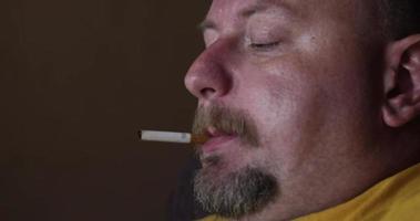 Man Lights And Smoking Cigarette In His Apartment video