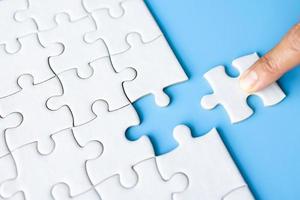 Jigsaw puzzle with missing piece. Completing final task, missing jigsaw puzzle pieces and business concept with a puzzle piece missing. photo