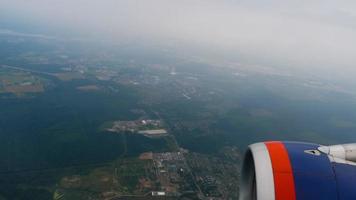 Blick aus dem Flugzeugfenster auf die Gegend. hoch in den Himmel fliegen. malerische Aussicht aus dem Flugzeugfenster video