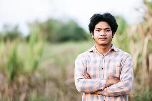 Portrait Asian young man smile with happy in corn field photo