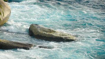 Turquoise waves rolled on the rocks, beach of Koh Miang island, Similan Islands, slow motion video