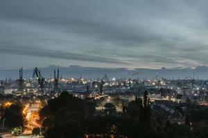 Morning panoramic view of poland city Gdansk with the industrial island in Mlyniska in background during the cloudy autumn morning photo