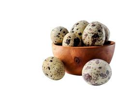 Quail eggs from quail, a collection of quail eggs on a wooden plate with isolated white background photo