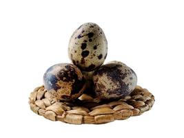 Quail eggs from quail, a collection of quail eggs on a wooden plate with isolated white background photo