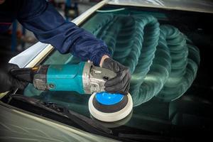 MAn polishes the front glass photo