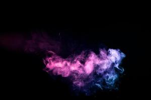 Colorful smoke of orange,  pink on a black isolated background. Background from the smoke of vape photo