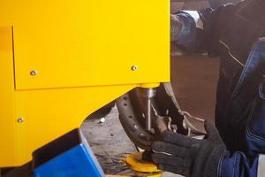 A close-up of a man fitter riveting brake photo